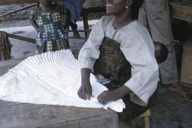 Image of Woman folding adire, Abeokuta