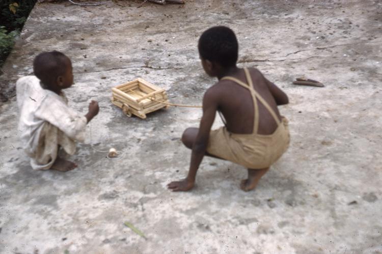 Image of Children playing with palm rib cart