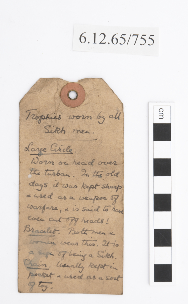 General view of label of Horniman Museum object no 6.12.65/755
