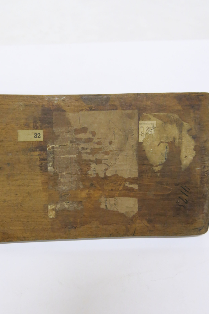 General view of the labels on the bottom of Horniman Museum object no nn17142