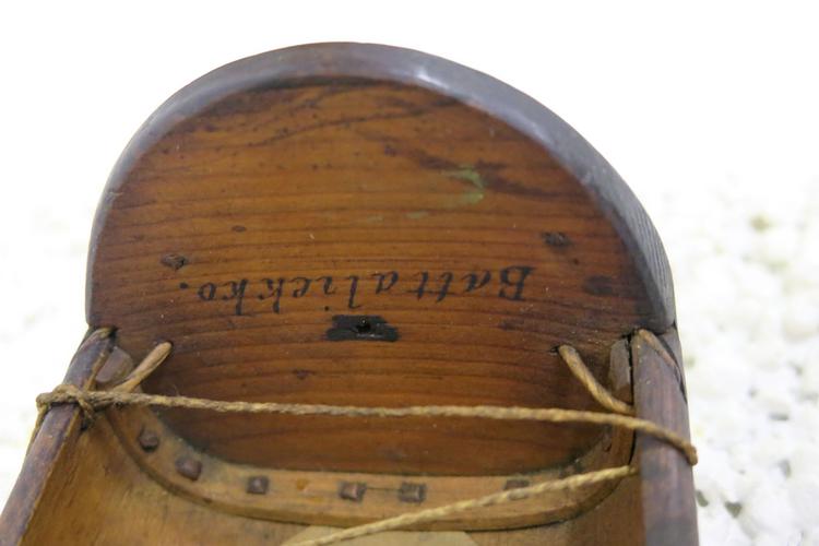 General view of the writing on the inside edge of the sled of Horniman Museum object no 32.53