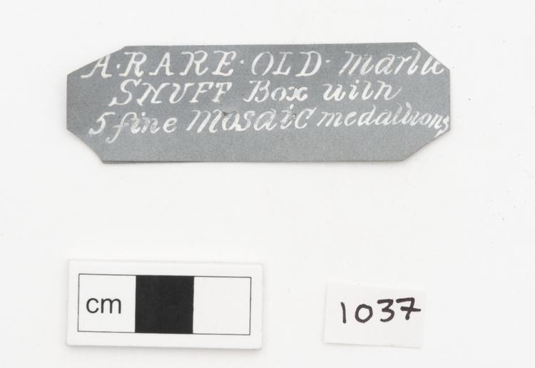 General view of label of Horniman Museum object no 1037