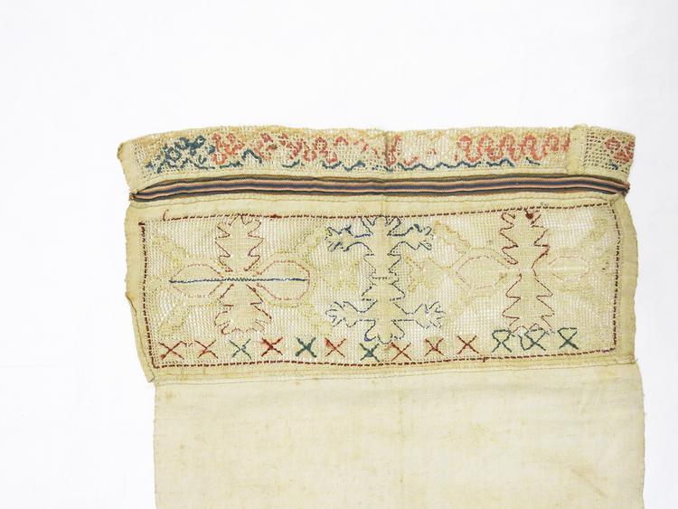 Detail view of embroidery of Horniman Museum object no nn5119