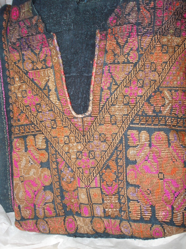 Detail view of embroidered neckline of Horniman Museum object no E1557.1