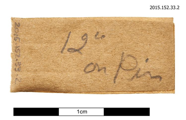 General view of spare string identification label with instruction for tuning pin winding of Horniman Museum object no 2015.152.33.2