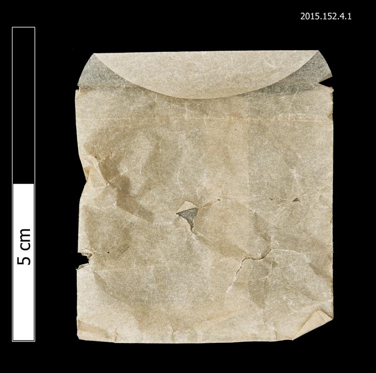 General view of envelope for spare string used for detached front board lock of Horniman Museum object no 2015.152.4.1