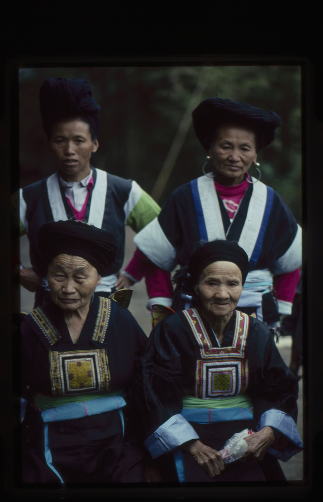 Image of 35mm slide: Grandmothers with embroidered squares on the fronts of their costumes.