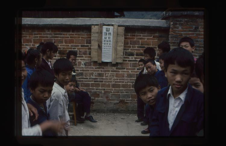 Image of 35mm slide: Eye test in the playground at a school
