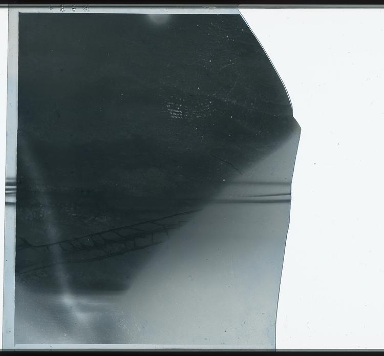 Image of Black and white negative of unknown blurry image, possibly view of ground from airplane window