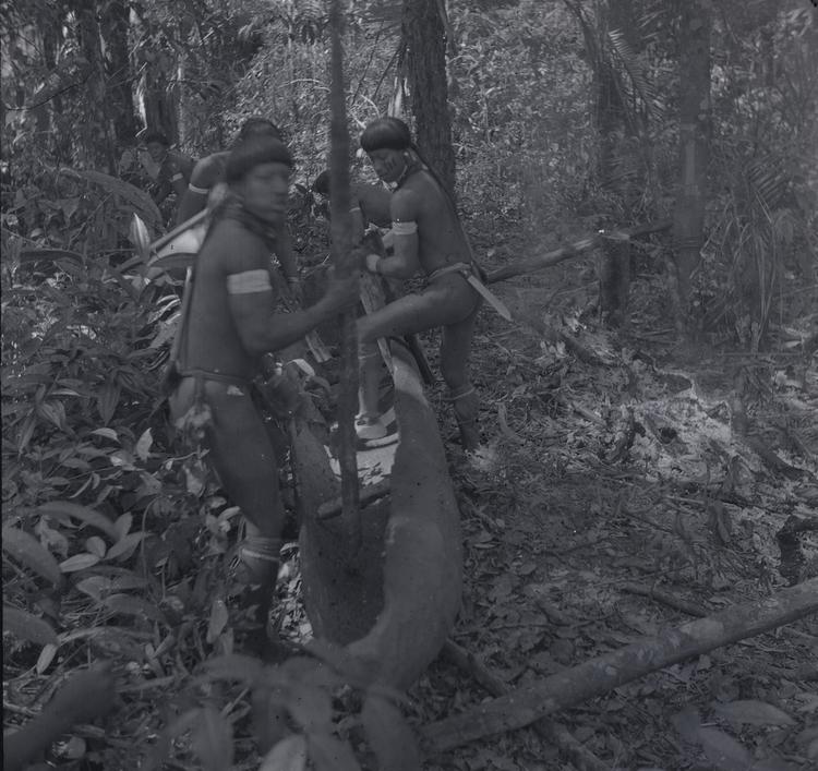 Image of Black and white negative  of five men building a canoe. Negative of photograph 41