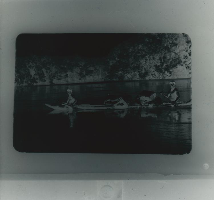 Image of Black and white negative of two Wai Wai tribes people  in a canoe