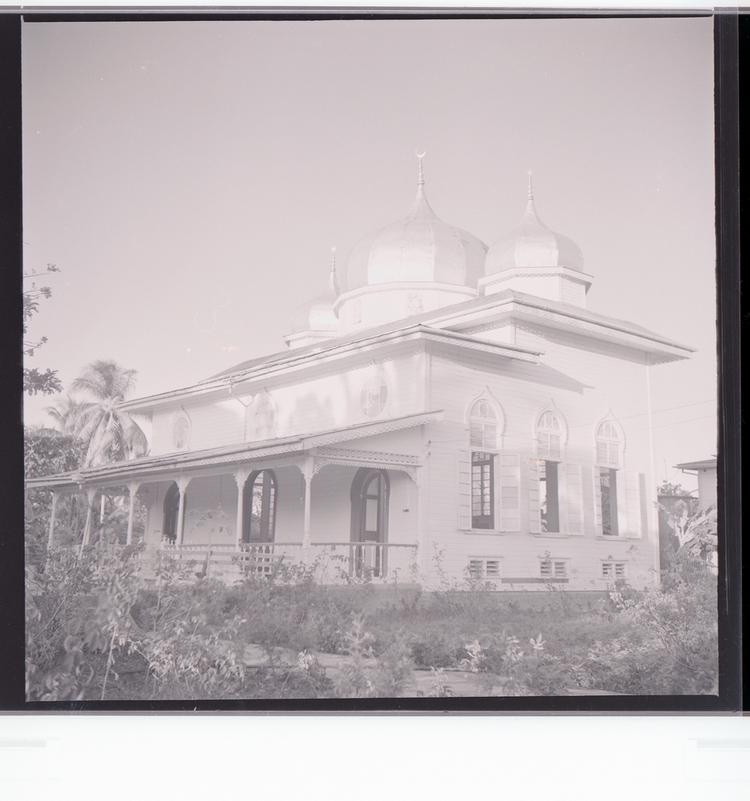 image of Black and white negative view of building with rounded turrets, side view