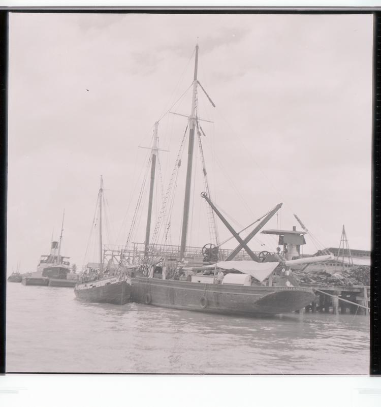 Image of Black and white negative of Lucille M. Smith boat and other boats docked