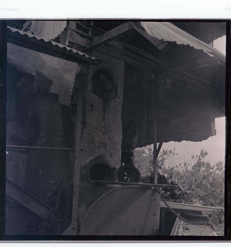 Image of Black and white negative view of inside a boat, coal processor?