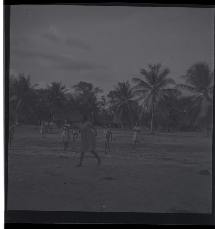 image of Black and white medium format negative (scanned positive) of a woman appearing to take part in a team game