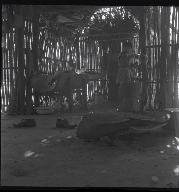 Image of Black and white medium format negative (scanned positive) inside a dark hut