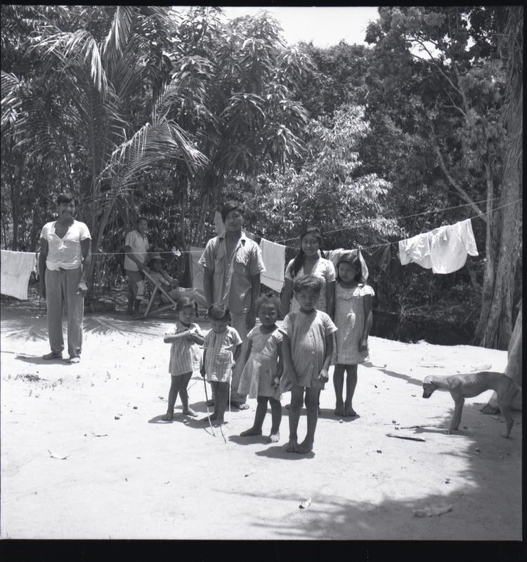 image of Black and white medium format negative (scanned positive)of a family group by a clothes line