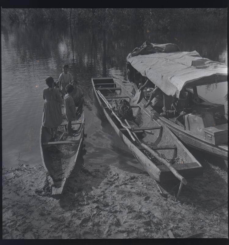 image of Black and white medium format negative (scanned positive) of 3 moored boats. The smallest  has 5 children in it.