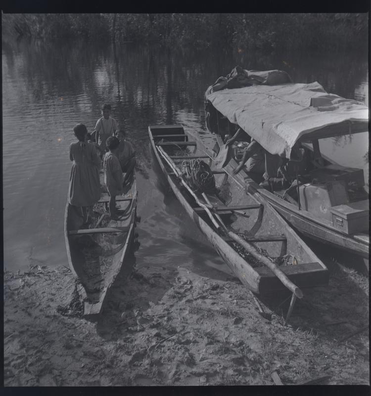 Image of Black and white medium format negative (scanned positive) of 3 moored boats. The smallest  has 5 children in it.