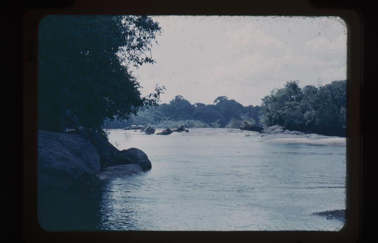 image of Colour slide of river with a rock in the foreground