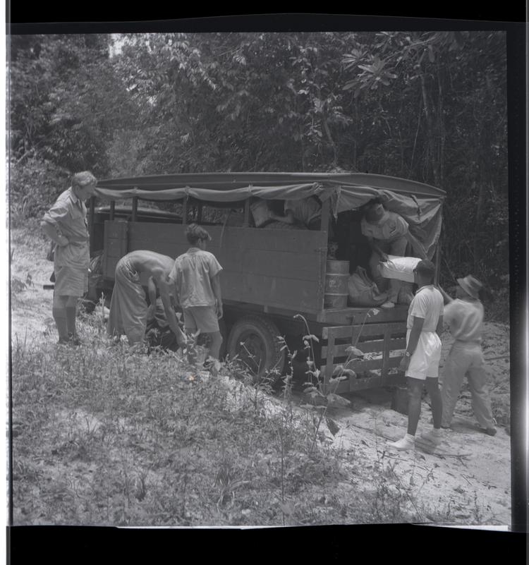 image of Black and white medium format negative of five people around a vehicle