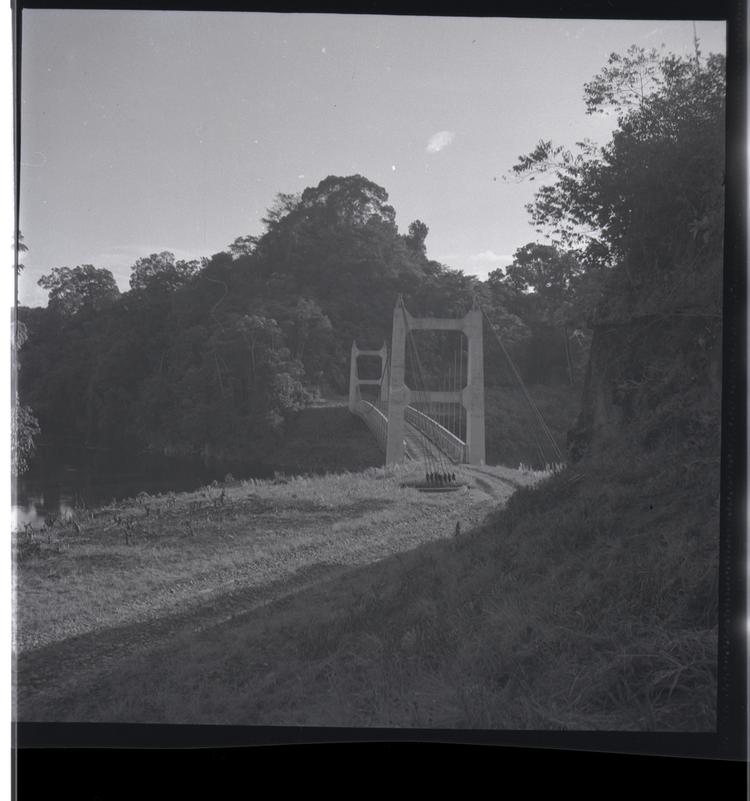 Image of Black and white medium format negative of road leading to a bridge