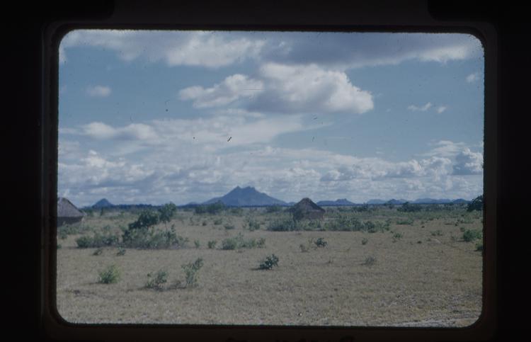image of Colour slide of landscape - buildings in mid ground and mountains in background