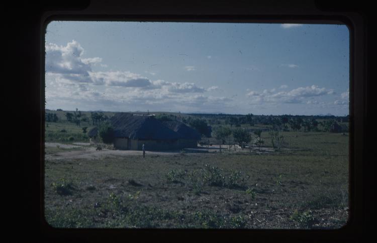 Colour slide of large building in grassy landscape with trees