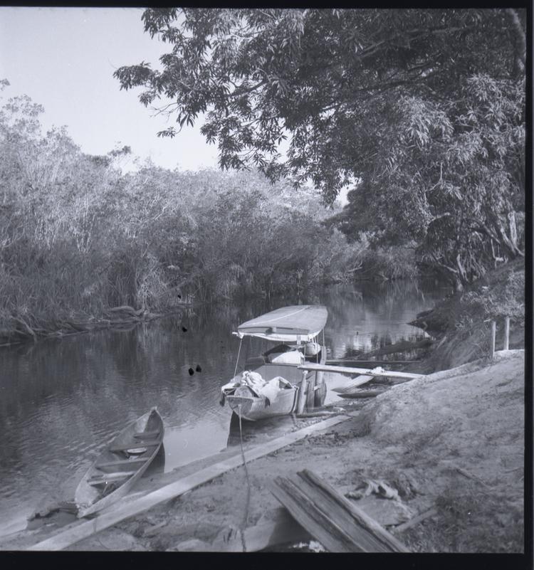 image of Black and white medium format negative (scanned positive) boat with awning moored on river bank