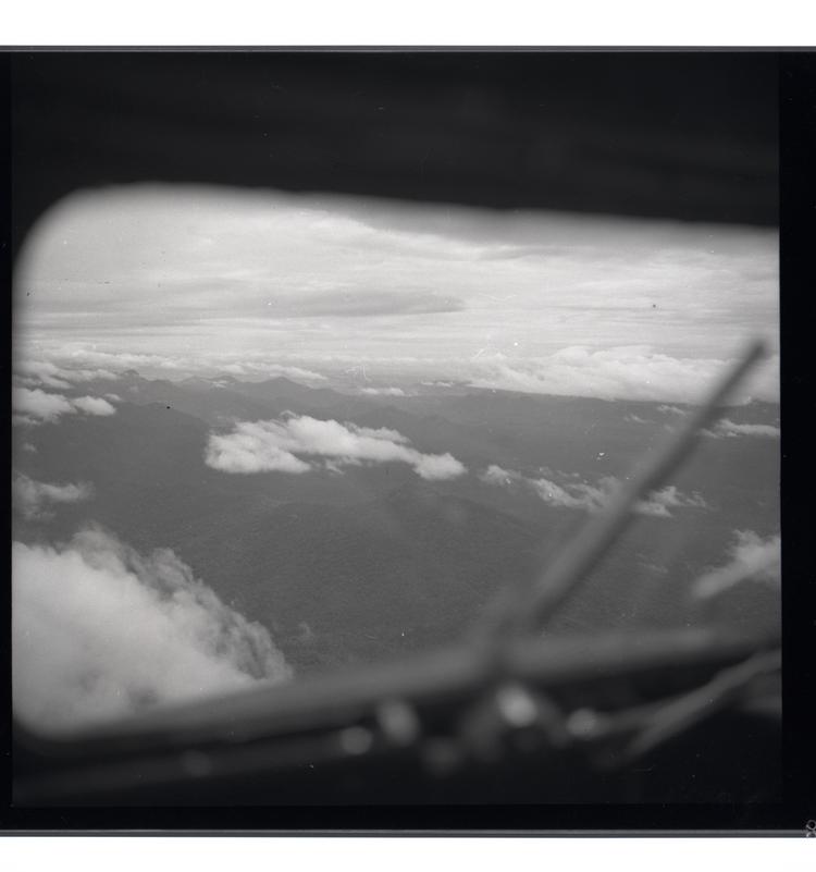 Black and white medium format negative of view from plane with window apparent