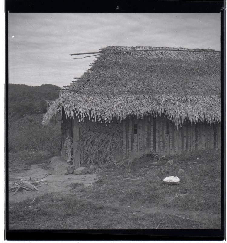 Black and white medium format negative of hut style building