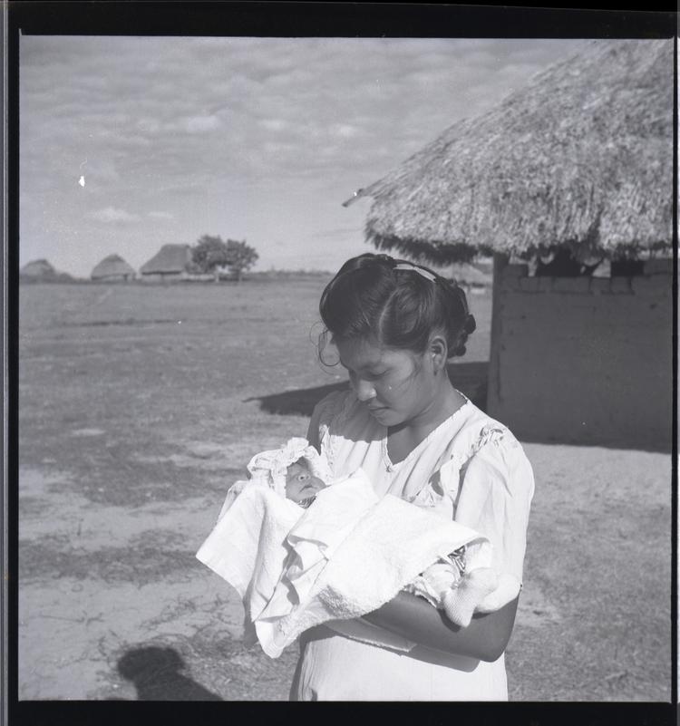 Black and white medium format negative of woman holding a baby