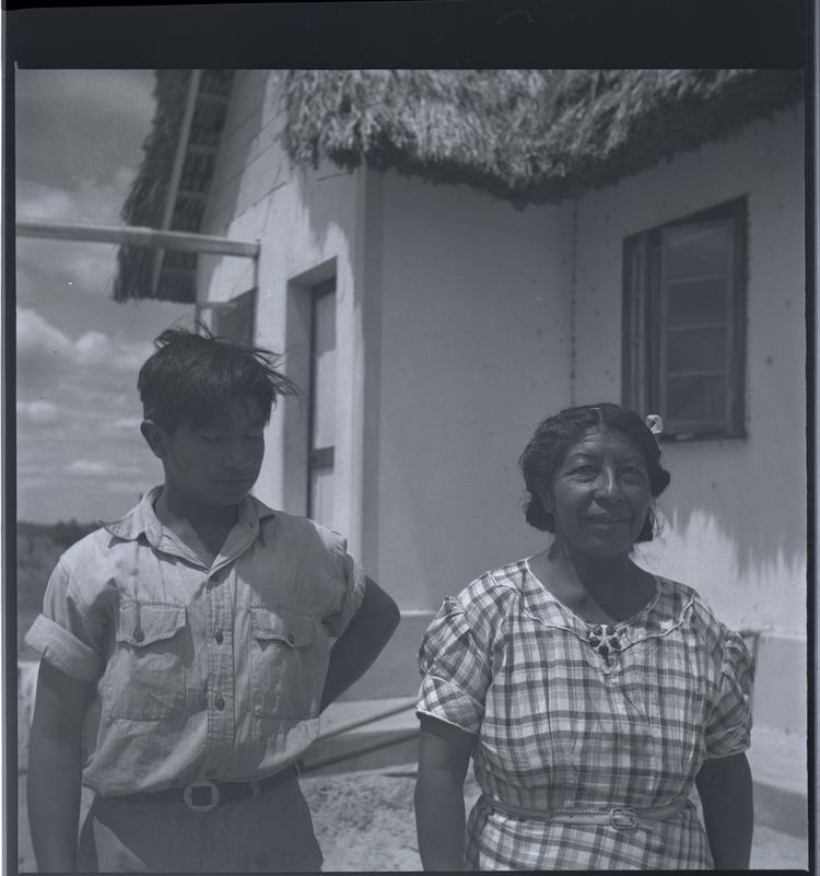 image of Black and white medium format negative of man and woman standing outside a building