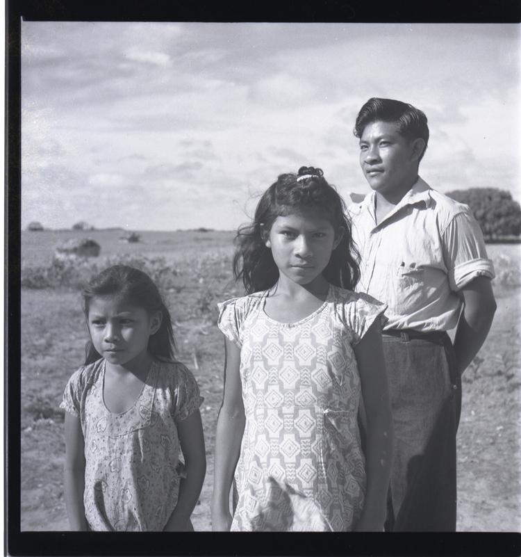 image of Black and white medium format negative of two indian girls and a man