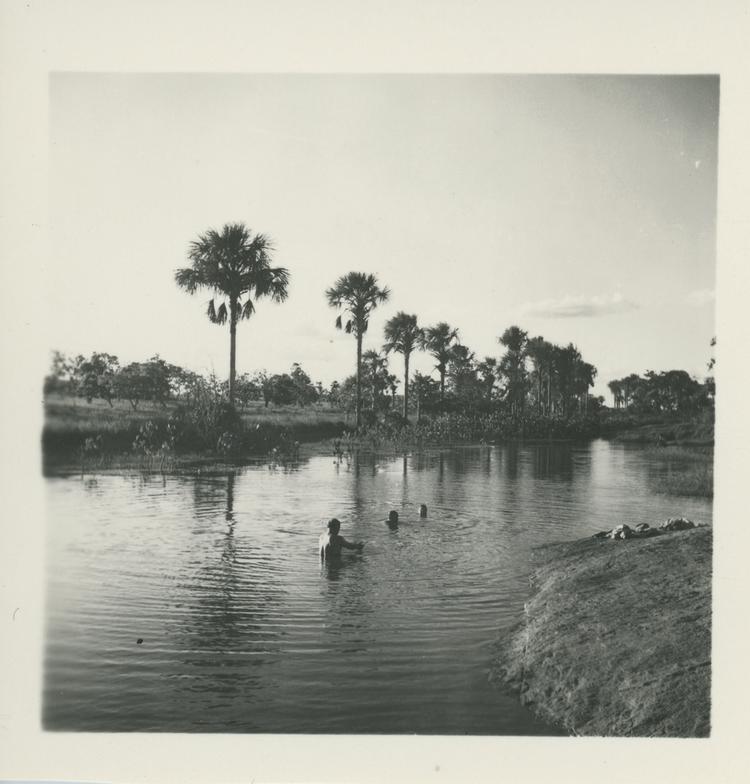 Black and white print of people bathing in a river