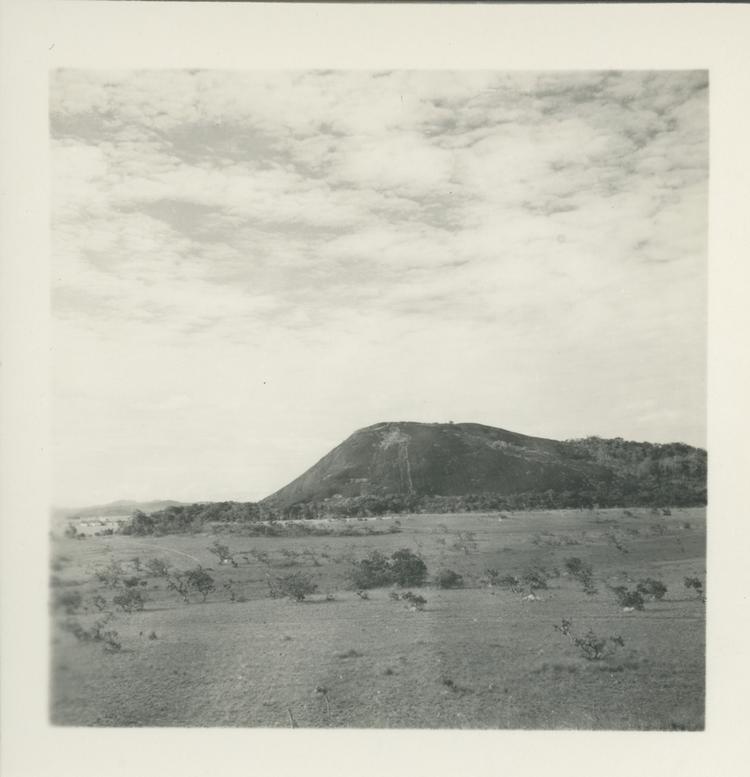 Black and white print landscape with mountain in background