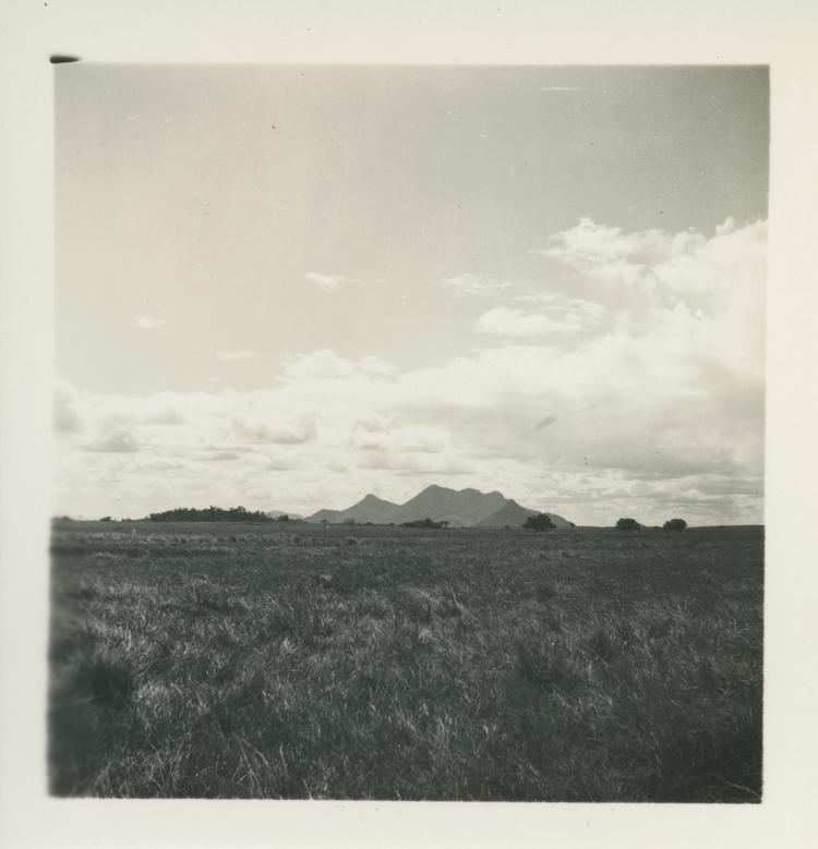 Black and white print of mountains in distance