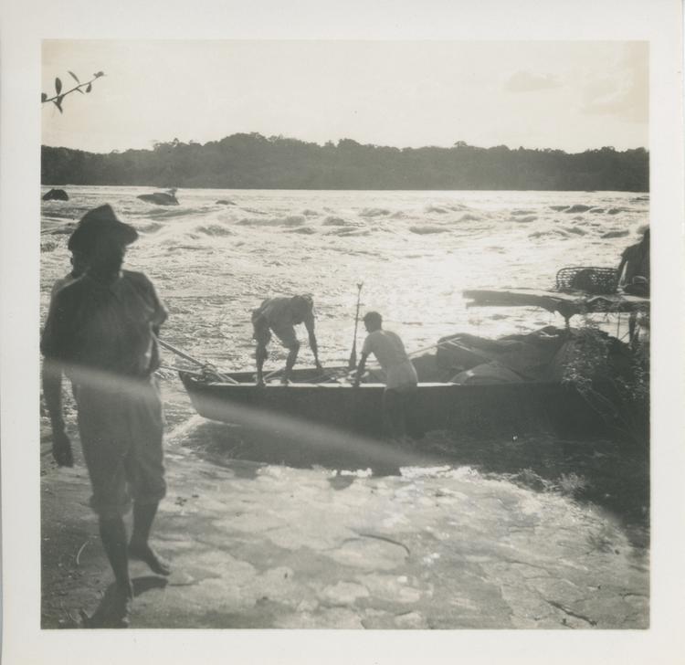 image of Black and white print of men and boats beside rapids on river