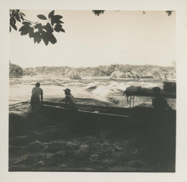 image of Black and white print of two men with boat beside rapids