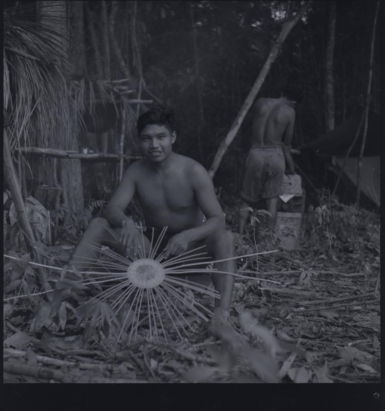 Black and white medium format negative of man making a basket