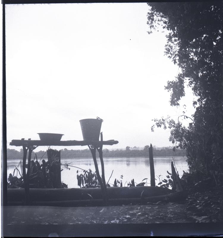 image of Black and white medium format negative of bucket and staging in silhouette with water and clouds behind