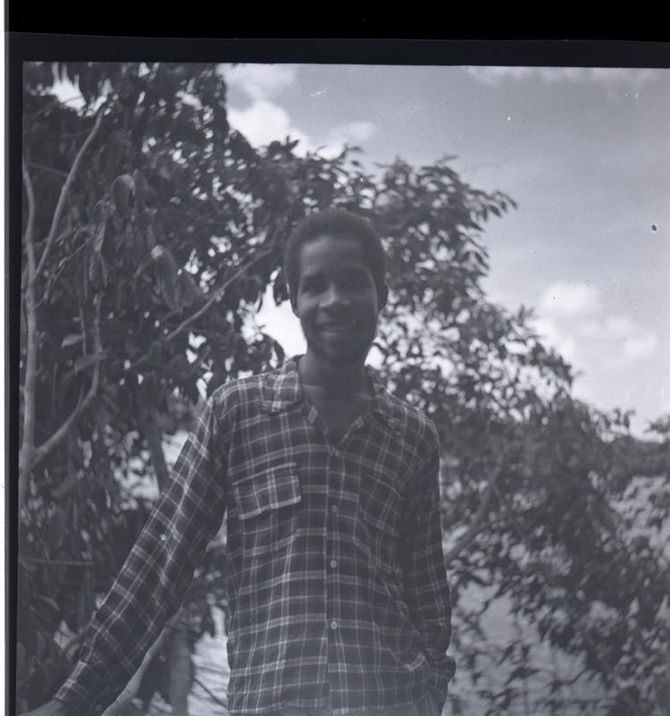 image of Black and white medium format negative of young man in check shirt