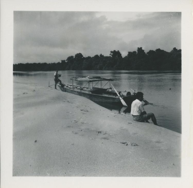 Image of Black and white print of moored boat and two men