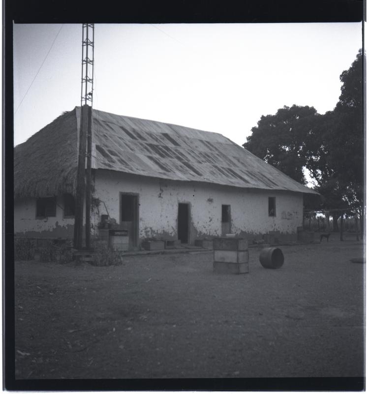 Black and white medium format negative of simple building in rural setting