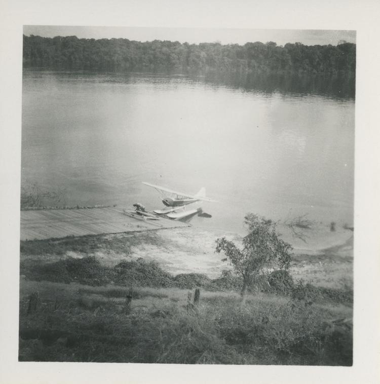 Image of Black and white print of seaplane on river by jetty