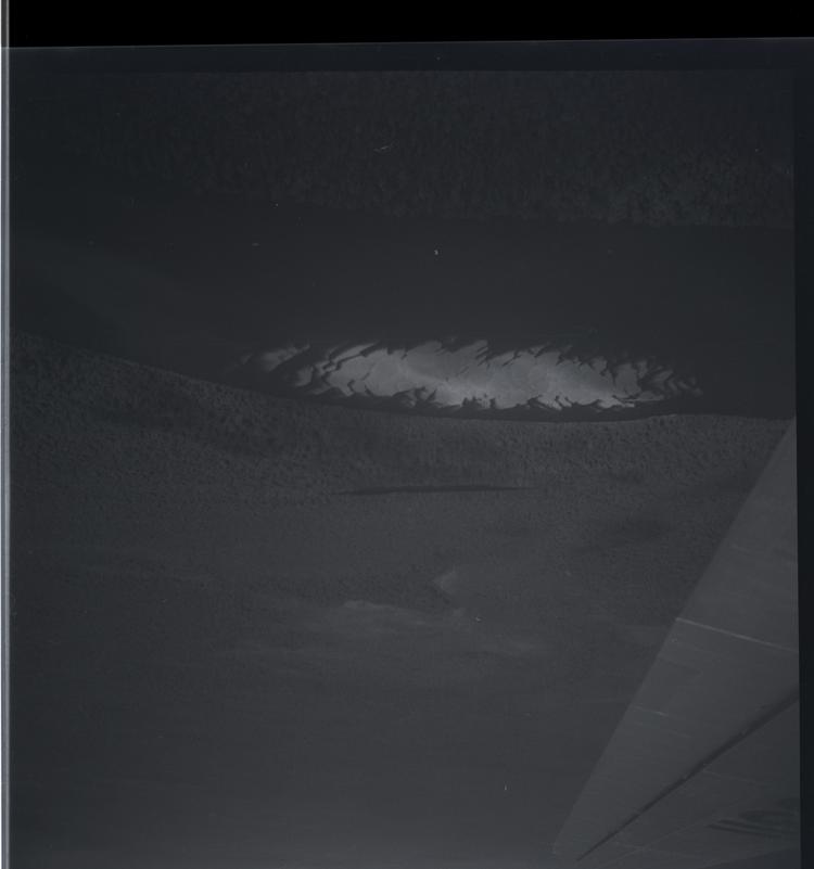 Image of Black and white medium format negative of aerial view of sandbanks with plane wing lower right corner