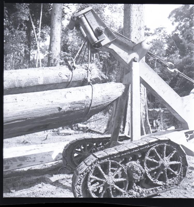 Image of Black and white medium format negative of a close up of a tractor lifting logs