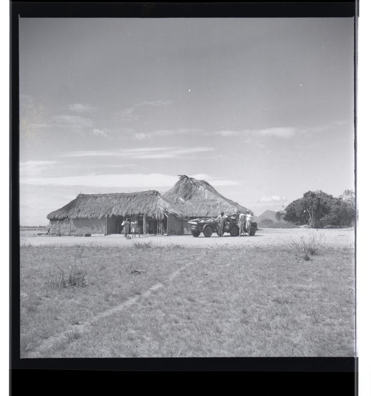 image of Black and white medium format negative of buildings with jeep in front