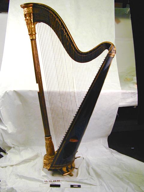 Lateral view from left of object no. 15.10.48/10. Image of double-action harp (museum no. 15.10.48/40).
