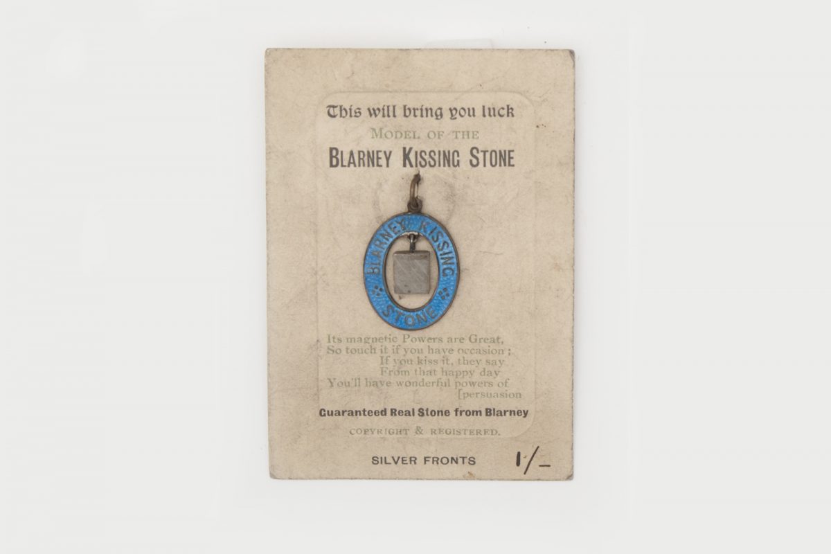 Trinket held on cardboard, text reads ' This will bring you luck, model of the Blarney kissing stone.